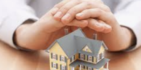 hands covering a home