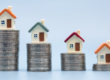 Little homes on top of money piles